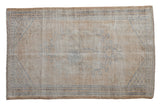 Hand-knotted distressed vintage Oushak rug with faded beige and denim blue floral vinery.