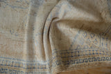 Vintage Oushak rug showing worn beige pile and denim blue geometric border details.