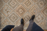 Distressed Oushak runner with geometric gul medallions in muted ivory, powder blue, and brown.