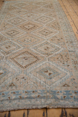 Distressed Oushak runner with repeating gul medallions, ivory and powder blue.