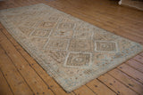 Distressed Oushak rug with geometric gul medallions, hook and latch motifs in ivory, bronze, powder blue.