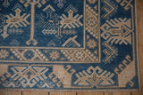 Distressed Melas runner corner, indigo blue geometric field, beige meandering vine border.