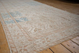 Distressed Oushak runner showing faded ivory border with dusty blue and pale bronze patterns.
