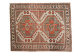 Distressed vintage Oushak square rug, double geometric medallion, time-softened red, ivory, and blue.