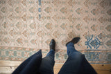A view from above the distressed Oushak runner showing its geometric trellis pattern and even wear.