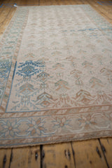 Angled view of a distressed Oushak runner highlighting its geometric pattern and soft color abrashes.