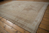 Distressed pale coffee brown wave border detail on a vintage Oushak carpet.