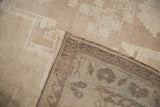 Distressed short pile and intact side selvage on a vintage Oushak rug.