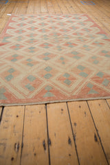 Distressed Oushak rug, pinwheel and pawn motifs in ivory, pale red, and silver.