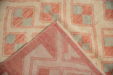 Hand-knotted foundation and distressed pile of vintage Oushak rug, ivory and pale red.