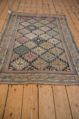Unusually fine weave of the antique Shirvan rug, with multi-paneled floral bouquets and pawn border.