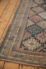 Antique Shirvan rug border's fine weave, intricate pawn motifs in pink, navy, and beige.