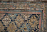 Antique Shirvan rug's fine weave, intricate stepped patterns, unique navy, sand, pink borders.