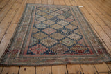 Antique Shirvan rug corner, navy, pink, beige pawn motif border, tattered fringe, visible wear.
