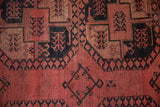 Textural detail of vintage Ersari rug; geometric gul design in dusty rose, navy, and beige.