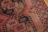 Textured Ersari carpet: blush and navy gul panel, meandering vine lattice border.