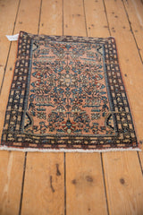 Detail of vintage Farahan Sarouk rug, dusty rose field, short pile, blue and bronze floral vinery.