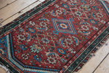 Vintage Hamadan rug fragment: cherry red Herati field and dusty teal serpent border.