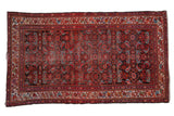 Vintage Persian Hamadan rug, deep red Herati motif field, colorful meandering vine border.