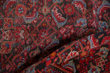 Folded vintage Hamadan rug, Herati motif, textured pile, red, charcoal, sky blue.