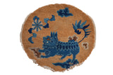 Antique Peking round rug with pictorial foo dog and blue cloudband motifs, sand, early 20th century.