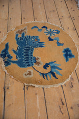 Detailed contour of cobalt blue cloudband and floral motifs on a sand Peking rug.