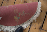 Reverse of this Nichols Art Deco round rug, showing the 'CHINA' stamp, plainweave, and fringe.