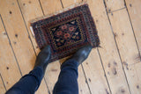 Vintage Afshar mat with navy, terracotta, ivory geometric pawn motifs and visible fringe, 1'x1'5