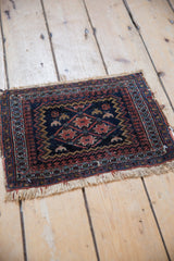 Vintage Afshar rug corner showing navy blue, terracotta pawn motif and secure fringe.