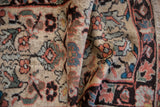 Folded vintage Lilihan rug showing texture, visible knot heads, and subtle asymmetric floral motifs.