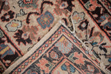 Corner detail of vintage Persian Lilihan rug with visible foundation and tattered fringe.