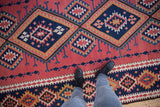 Vintage Persian Kilim runner with repeating geometric serrated diamonds in dusty blush and navy blue.