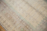 Short, even pile texture on a distressed vintage Oushak rug, with faded ivory and seafoam patterns.