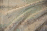 Textured surface of the distressed vintage Oushak rug, revealing soft ivory, beige, and seafoam green.
