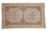 Distressed vintage Oushak carpet, double geometric medallions with rams horn motifs, abrashed neutral tones. 6'3