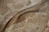 Distressed vintage Oushak carpet showing textured pile, even wear, and neutral tones.