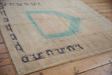 Distressed Oushak rug with aqua blue prayer mehrab and dark slate border motifs.