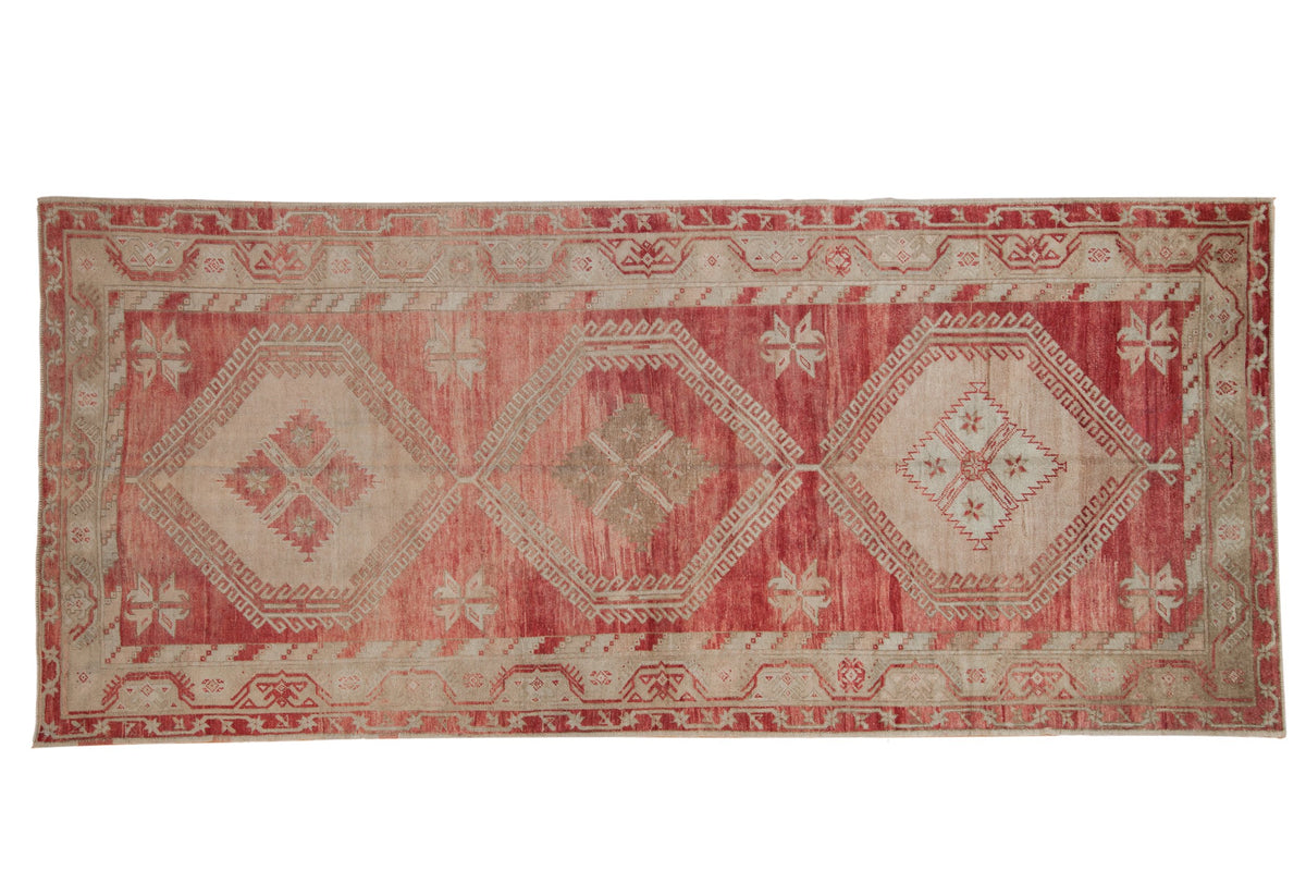 Vintage distressed Oushak runner with three oversized diamond medallions in dusty raspberry red and sand.