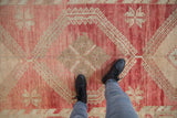 Evenly worn low pile showing the geometric medallions of a vintage Oushak runner.