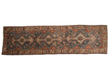 Vintage distressed Hamadan runner with a triple medallion pattern in dusty denim blue, madder red, and ivory.
