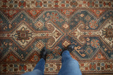 Decorative, even wear on a vintage Hamadan runner with dusty blue and red geometric medallions.