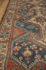 Angled view showing the even wear and storied texture of this vintage Hamadan runner.