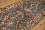 Angled view of the Hamadan runner's even wear, with geometric medallions in dusty blue and madder red.