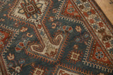Even wear on a vintage Hamadan rug showing geometric motifs in dusty denim blue and madder red.