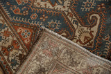 Folded corner of a vintage Hamadan runner displaying the hand-knotted foundation and weave.