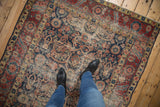 Northwest Persian rug border and field with ornate florals and significant foundation wear.