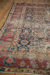 Vintage Northwest Persian rug showing wear, foundation, and navy, red, sand boteh design.