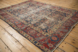 Worn floral and serrated leaf main border on a vintage Northwest Persian rug corner.