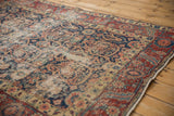 Close-up of the vintage Northwest Persian rug's navy field with faded pile and exposed foundation.
