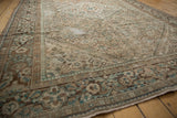 Distressed vintage Hamadan rug detail with worn beige, brown, and dusty green Herati pattern.